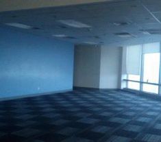 an empty room with blue walls and checkered floor