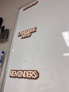 stickers on the side of a refrigerator that says language arts reminders and erasers