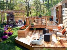 an outdoor deck with chairs and plants on it