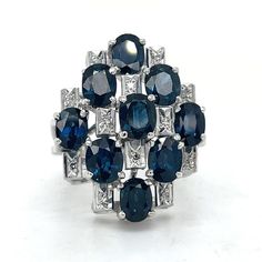 "Art Deco Cocktail Sapphire & Diamond Ring, 5CT Oval Sapphire Ring, 18k White Gold, Statement sapphire ring, Estate Jewelry, Unique Vintage ring \"\"\"Jewelry Material: White Gold 18k (the gold has been tested by a professional) Total Carat Weight: 5.1ct (Approx.) Total Metal Weight: 10.76g Size:7 US \\ 17.35mm (inner diameter) Grading Results: Stone Type: Sapphire Shape: Oval Carat: 5ct (Approx.), Stones quantity:9 Color: Blue  Grading Results: Stone Type: Diamond Shape: Single cut  Carat: 0.10 Oval Sapphire Multi-stone Diamond Ring, Oval Multi-stone Sapphire Diamond Ring, Sapphire Multi-stone Oval Diamond Ring, Oval Diamond Cut Sapphire Ring Fine Jewelry, Sapphire Cluster Ring Hallmarked, Hallmarked Sapphire Cluster Ring, Oval Multi-stone Sapphire Cluster Ring, Hallmarked Oval Sapphire Diamond Ring, Oval Sapphire Hallmarked Diamond Ring