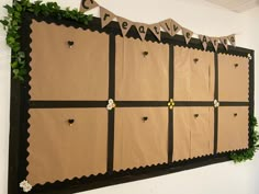 a bulletin board decorated with paper flowers and bunting