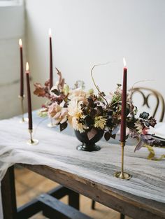 a table with candles and flowers on it