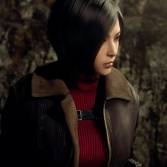 a woman with black hair wearing a red sweater and brown leather jacket standing in front of a rock wall