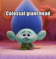 a troll with blue hair standing in front of a purple background and the caption colossal giant head