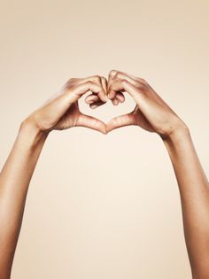 two hands making a heart shape with the words gettyimages written on it