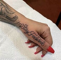 a woman's hand with the word love written in cursive writing on it