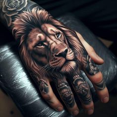 a man's hand with a lion and roses tattoo on the left hand,