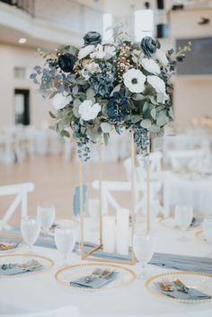 the centerpieces are decorated with blue and white flowers