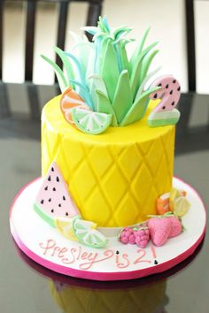 a pineapple cake decorated with fruit and decorations