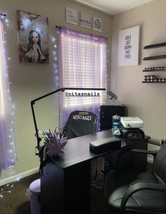 a room with a desk, chair and pictures on the wall