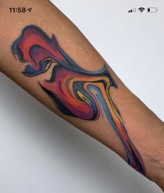 a person's arm with a colorful tattoo design on the left side of their arm