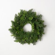 a green wreath is hanging on the wall