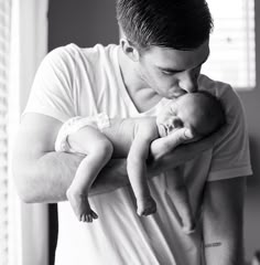 a man holding a baby in his arms