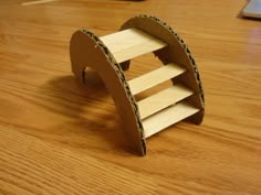 a small wooden object sitting on top of a hard wood floor