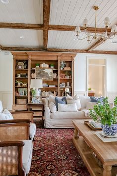 a living room filled with furniture and a rug on top of a wooden coffee table