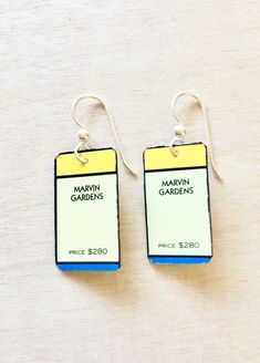 pair of earrings with name tags attached to them