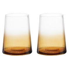 two glasses sitting next to each other on a white surface