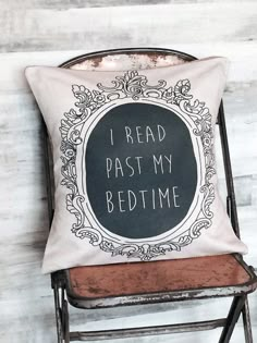 a chair with a pillow that says i read past my bedtime