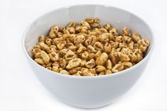 a white bowl filled with cereal on top of a table