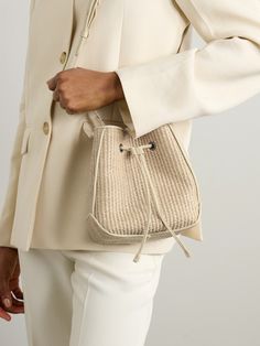 Brunello Cucinelli's bag re-imagines classic bucket styles for summer. It's been crafted in Italy from raffia and has adjustable leather straps tipped with the label's signature Monili beads. The compact size fits your phone, sunglasses and keys. Designer Summer Straw Bucket Bag, Designer Bucket Shoulder Bag For Spring, Designer Summer Bucket Bag For Vacation, Classic Summer Vacation Bags, Designer Summer Bucket Bag With Leather Handles, Elegant Woven Leather Bucket Bag For Travel, Designer Bucket Bag For Summer, Elegant Straw Shoulder Bag With Adjustable Strap, Elegant Leather Bucket Bag For Vacation