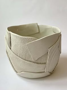 a white ceramic bowl with an unusual design on it's side and the bottom