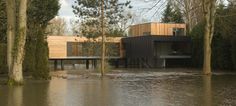 a flooded area with houses and trees in the foreground, surrounded by flood water