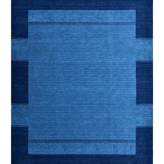 an area rug with blue and black squares on the bottom, in front of a white background