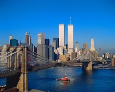 a boat is going down the river in front of some tall buildings and skyscrapers