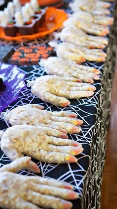 halloween treats lined up on a table with spider webs and sprinkles