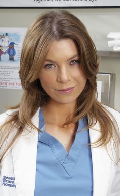 a woman in scrubs is posing for the camera