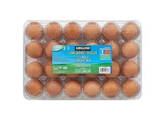 organic eggs in plastic container on white background