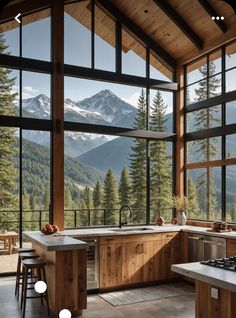 an open kitchen with large windows overlooking the mountains