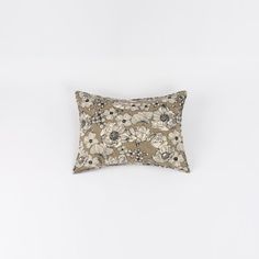 a pillow with flowers on it against a white background