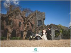 a bride and groom standing in front of an old house