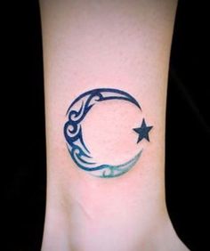 a small crescent and star tattoo on the side of a woman's foot,