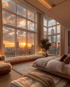 a bedroom with large windows and a view of the city at sunset in the background