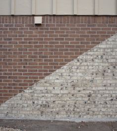 a red fire hydrant sitting in front of a brick wall