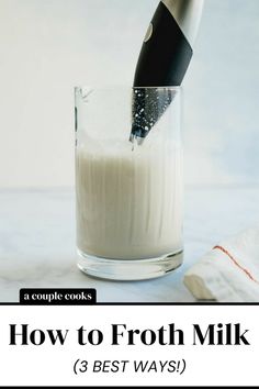 a glass filled with milk sitting on top of a table