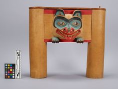 a wooden table with an animal design on it and a small box next to it