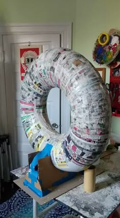 an inflatable object sitting on top of a table next to a mirror and other art work