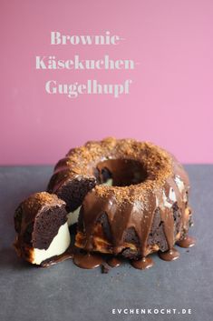 a chocolate bundt cake with white frosting on a black surface and the words brownie kasekuchen - gugelhupf