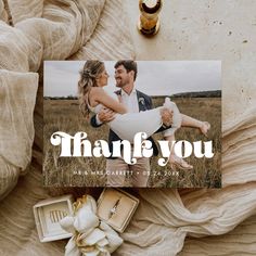 a wedding thank card with an image of a couple hugging and the words, thank you