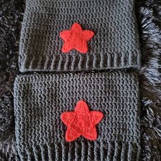 two crocheted stars are on top of each other, one is red and the other is gray