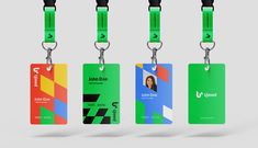 four id cards with lanyards attached to each one, all in different colors