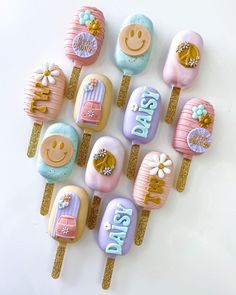 there are many decorated lollipops on top of each other in pastel colors