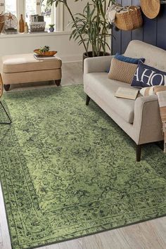 a living room filled with furniture and lots of green rugs on top of a hard wood floor