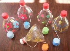 several empty plastic bottles sitting on top of a wooden table next to other small objects