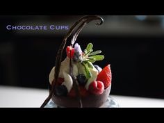 a chocolate dessert with berries, strawberries and mints on the top is shown