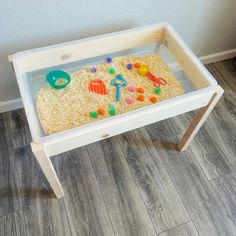 a child's sand and water table with toys in it