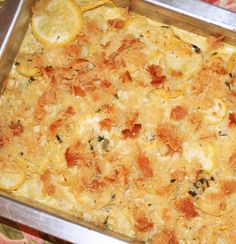 a casserole dish with lemons and other toppings in a metal pan